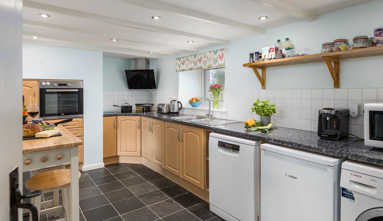 The kitchen is spacious and fully equipped for all your cooking needs.