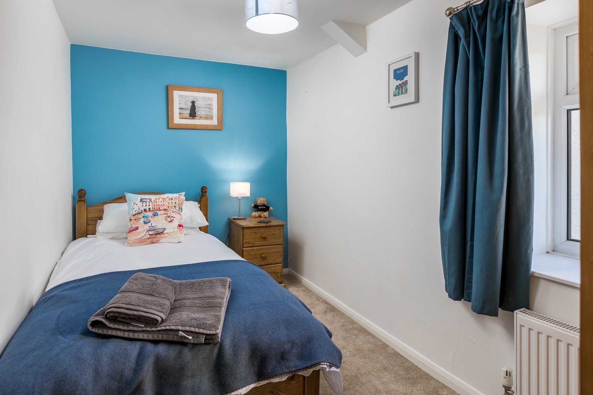 Bedroom 1 has a single bed, perfect for young adults or children.