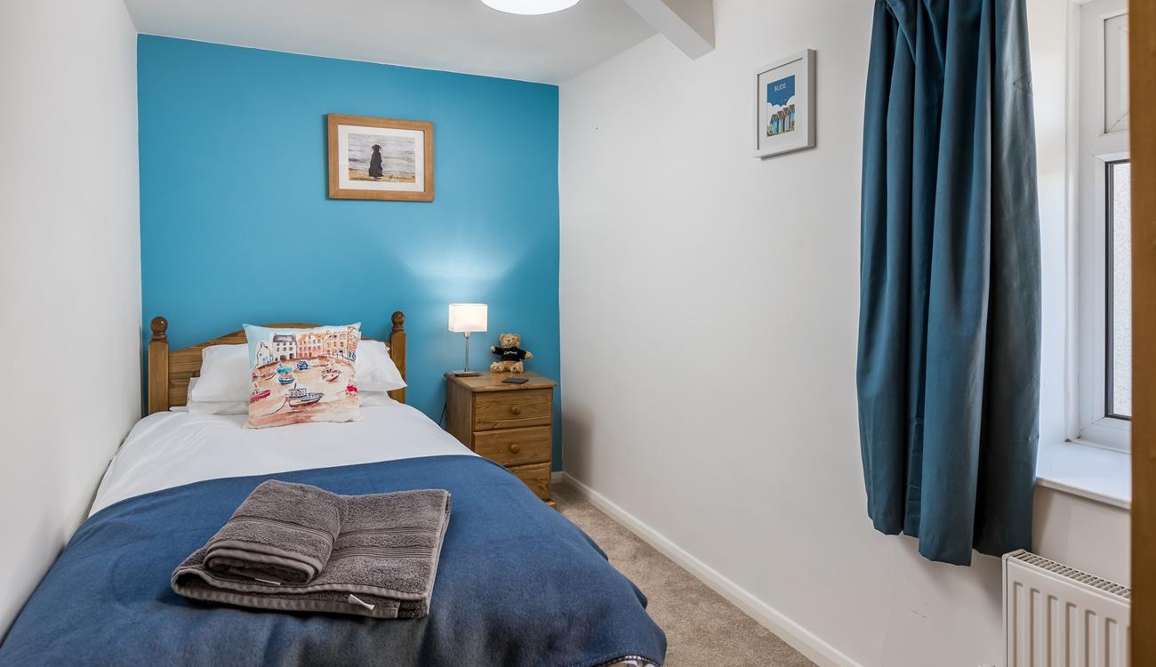 Bedroom 1 has a single bed, perfect for young adults or children.
