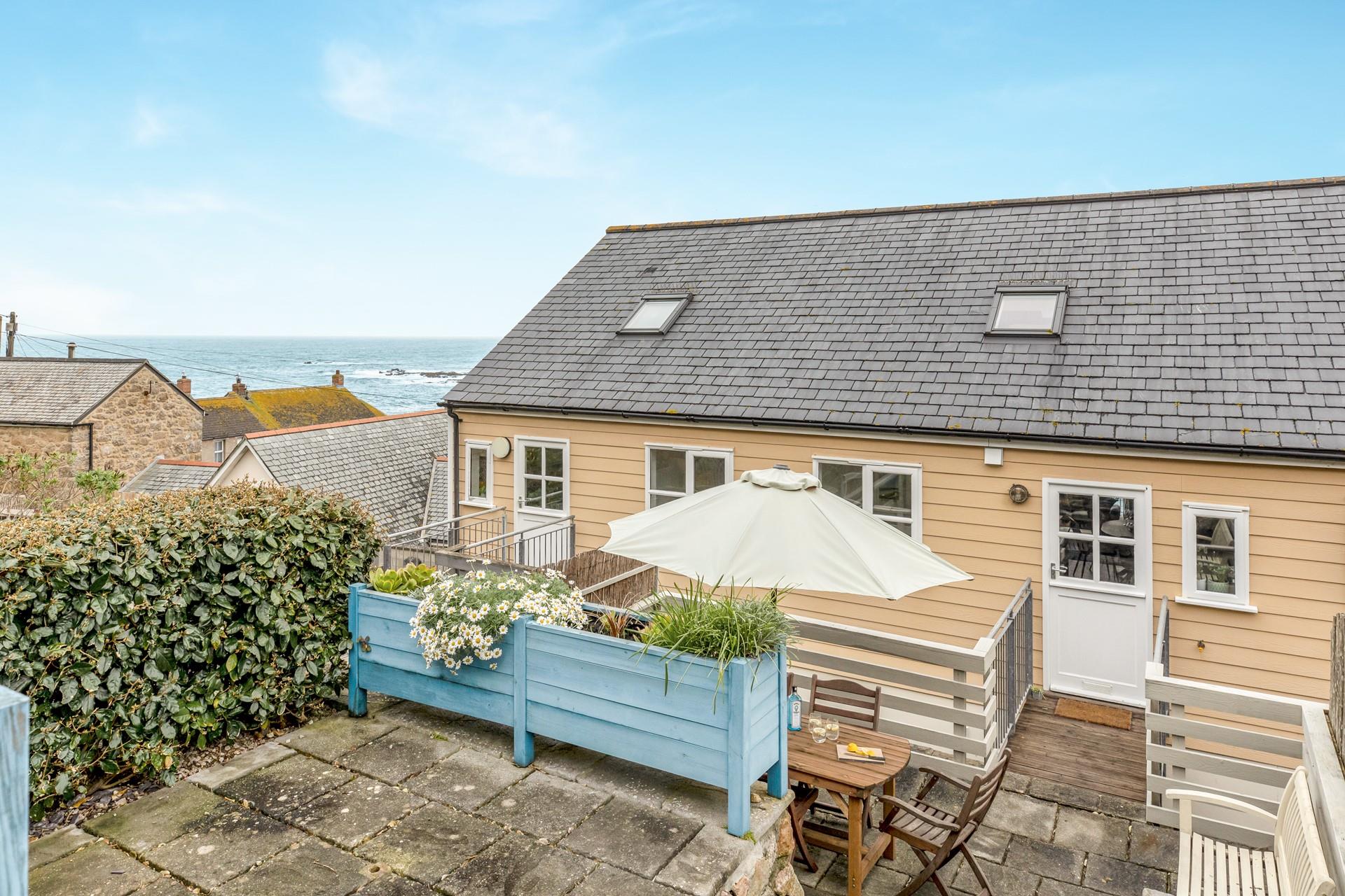 The garden benefits from sea views over Sennen.