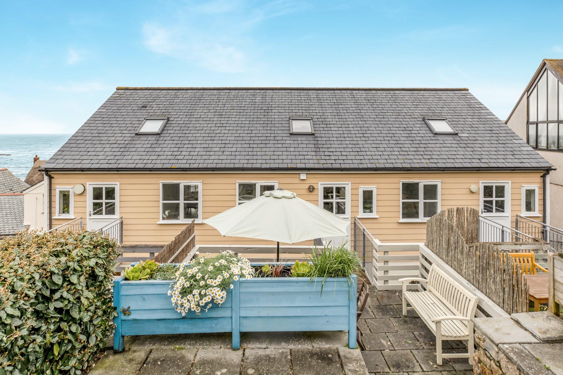 Soak up the sun in the garden, enjoying the sea glimpses.