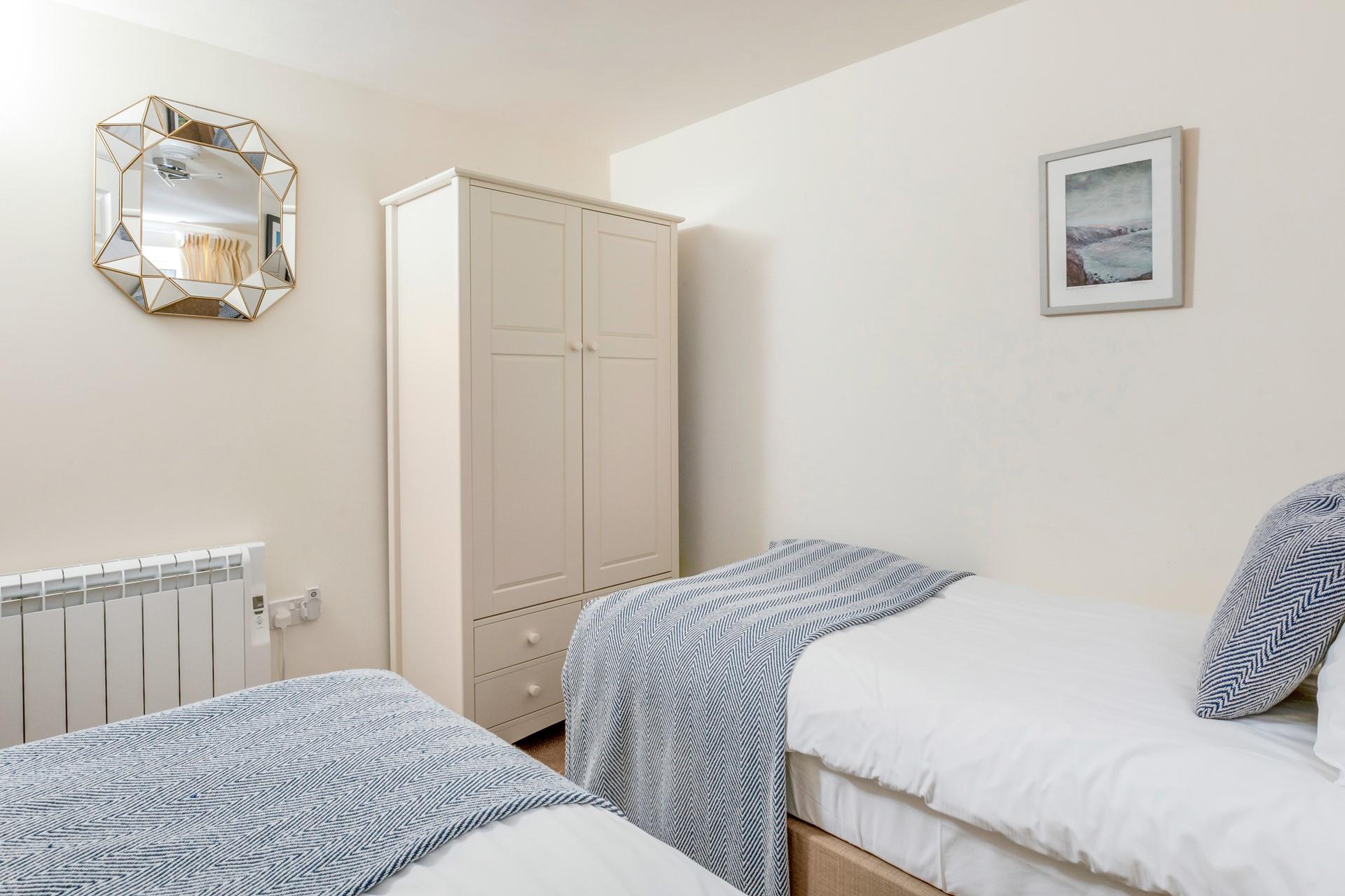 The twin room is decorated with calming tones.