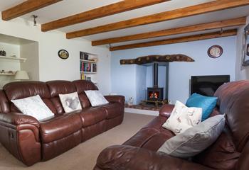 The second living area with its classic leather sofas and cosy woodburner is a great space to snuggle up.