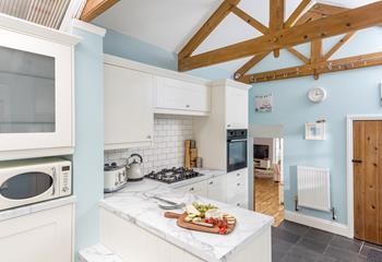 The kitchen is decorated in charming pastels and blends traditional features with modern features seamlessly.