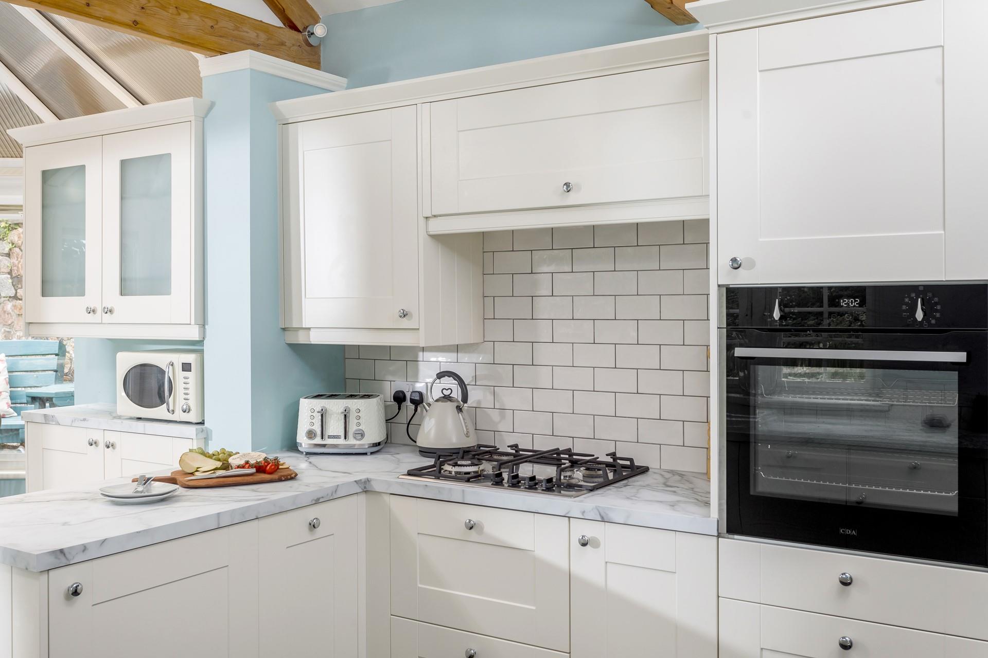 The breakfast bar area of the kitchen has a conservatory-style feel, perfect for enjoying your first coffee of the day and watching the sunrise!