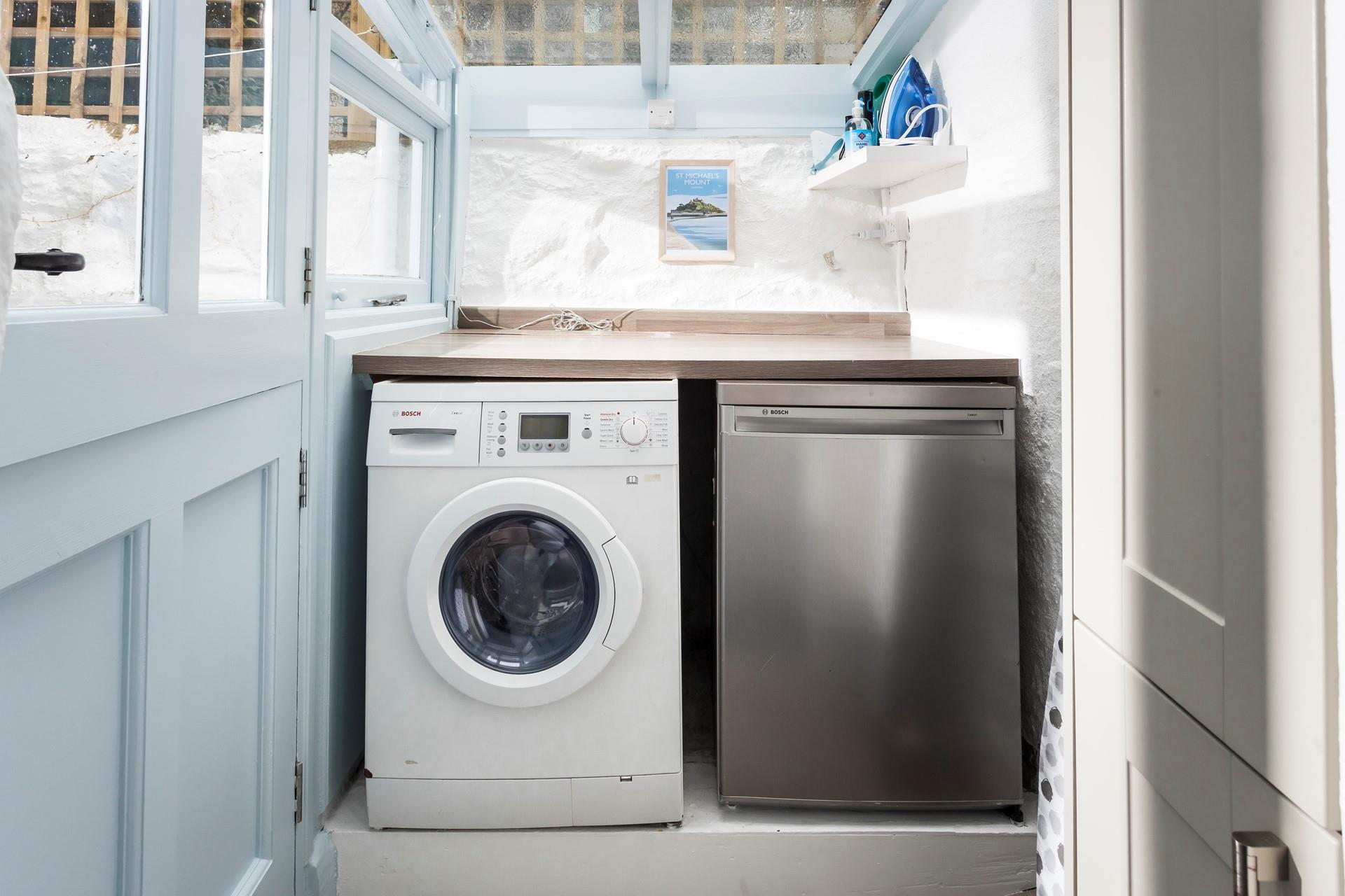 There is a fridge and washing machine in the utility room.