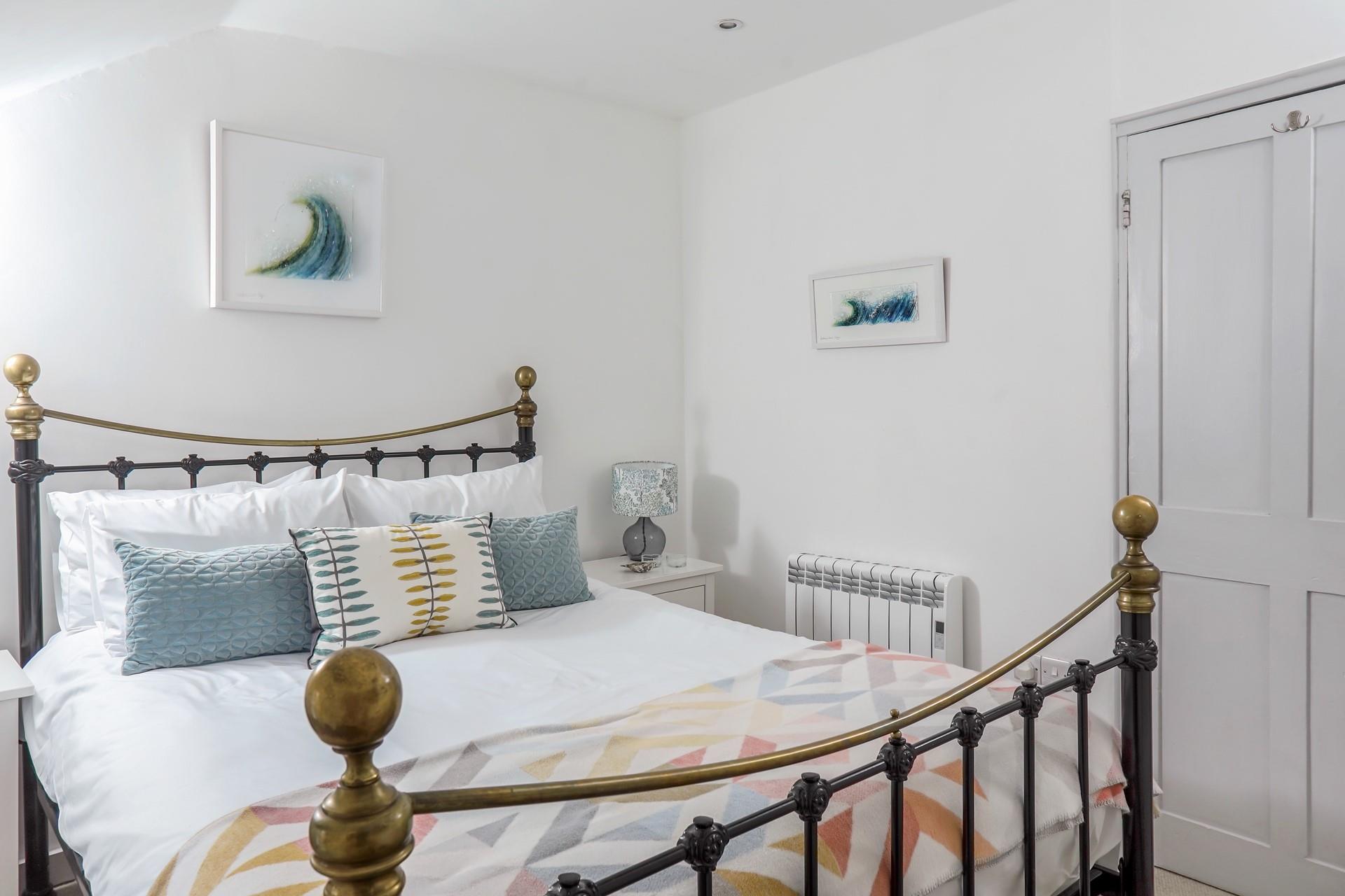 The bedroom is decorated with calming blue, green and white tones.