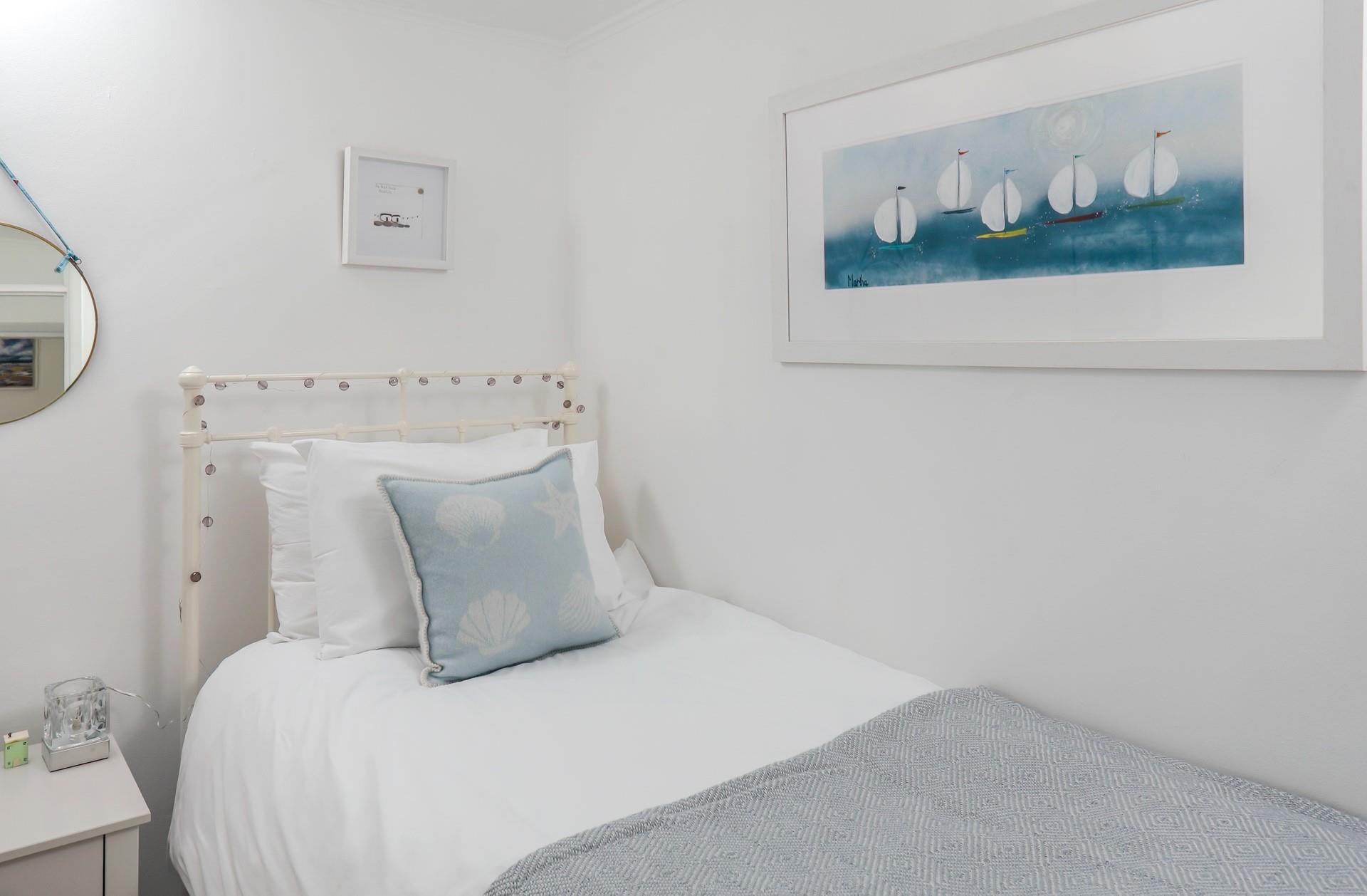 Bedroom 3 has a single bed and lovely boat artwork!