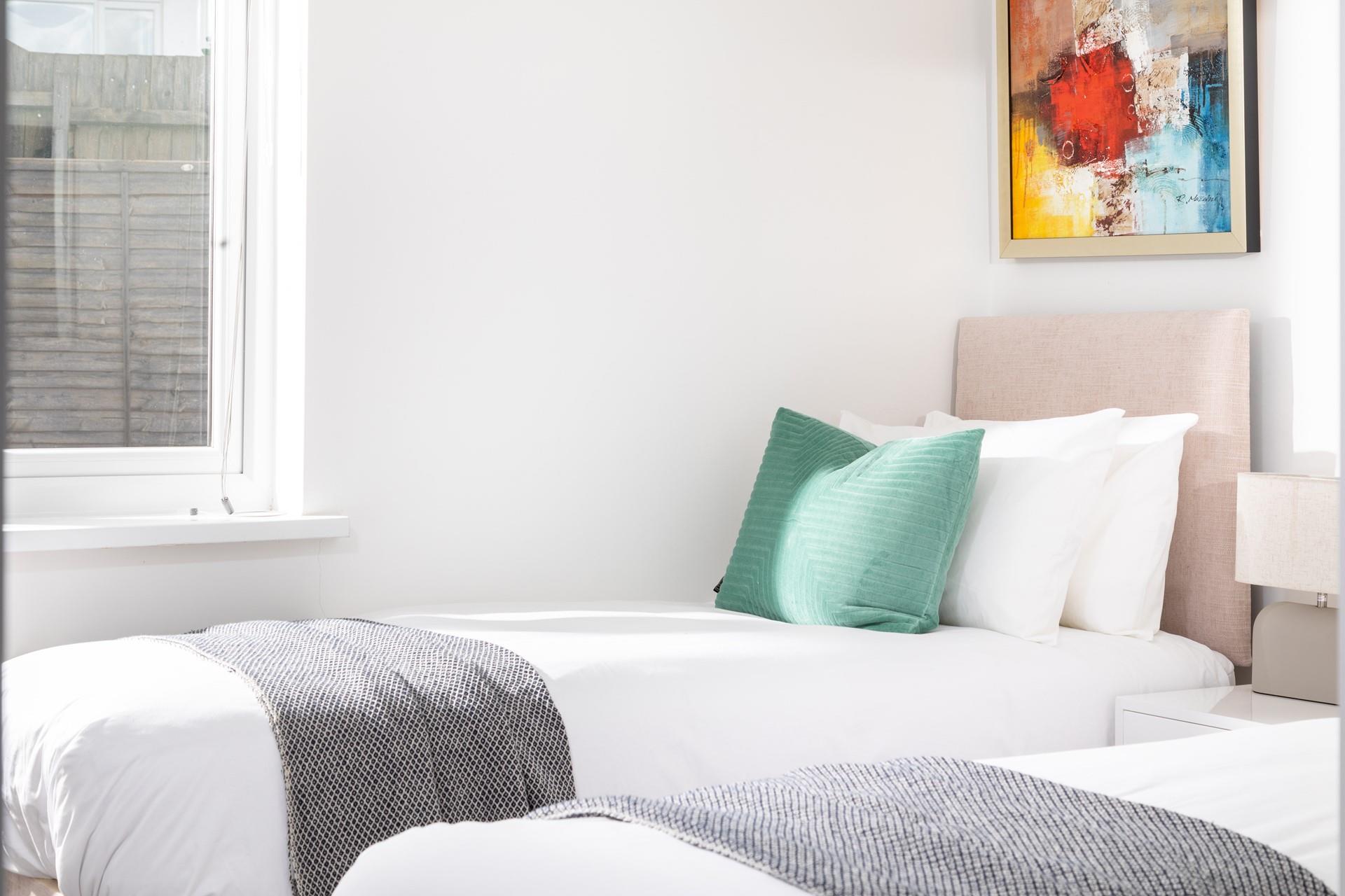 Bedroom 2 has cosy twin beds, perfect for children and young adults.