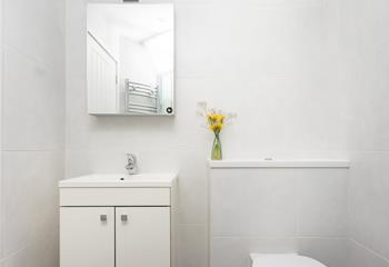 Classic white tiles ensure the bathroom is a fresh, bright space.