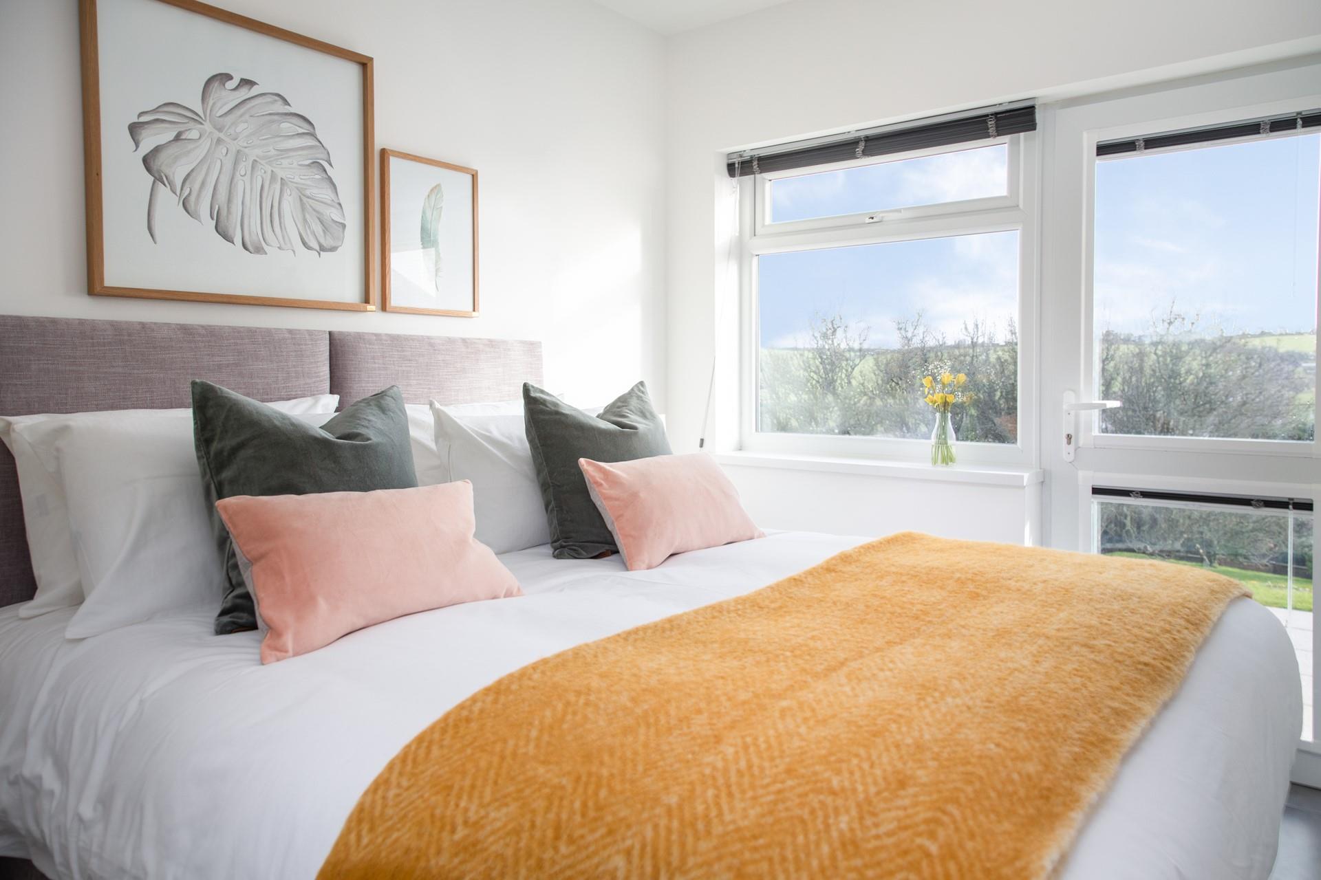 Bedroom One benefits from a door onto the patio so you can grab a mug of your favourite hot drink and watch the sunrise.