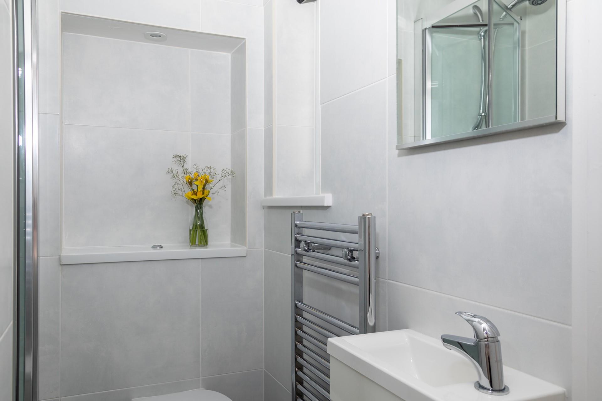 Classic white tiles make the bathroom a bright and fresh space.