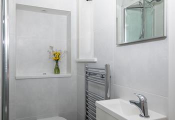 Classic white tiles make the bathroom a bright and fresh space.