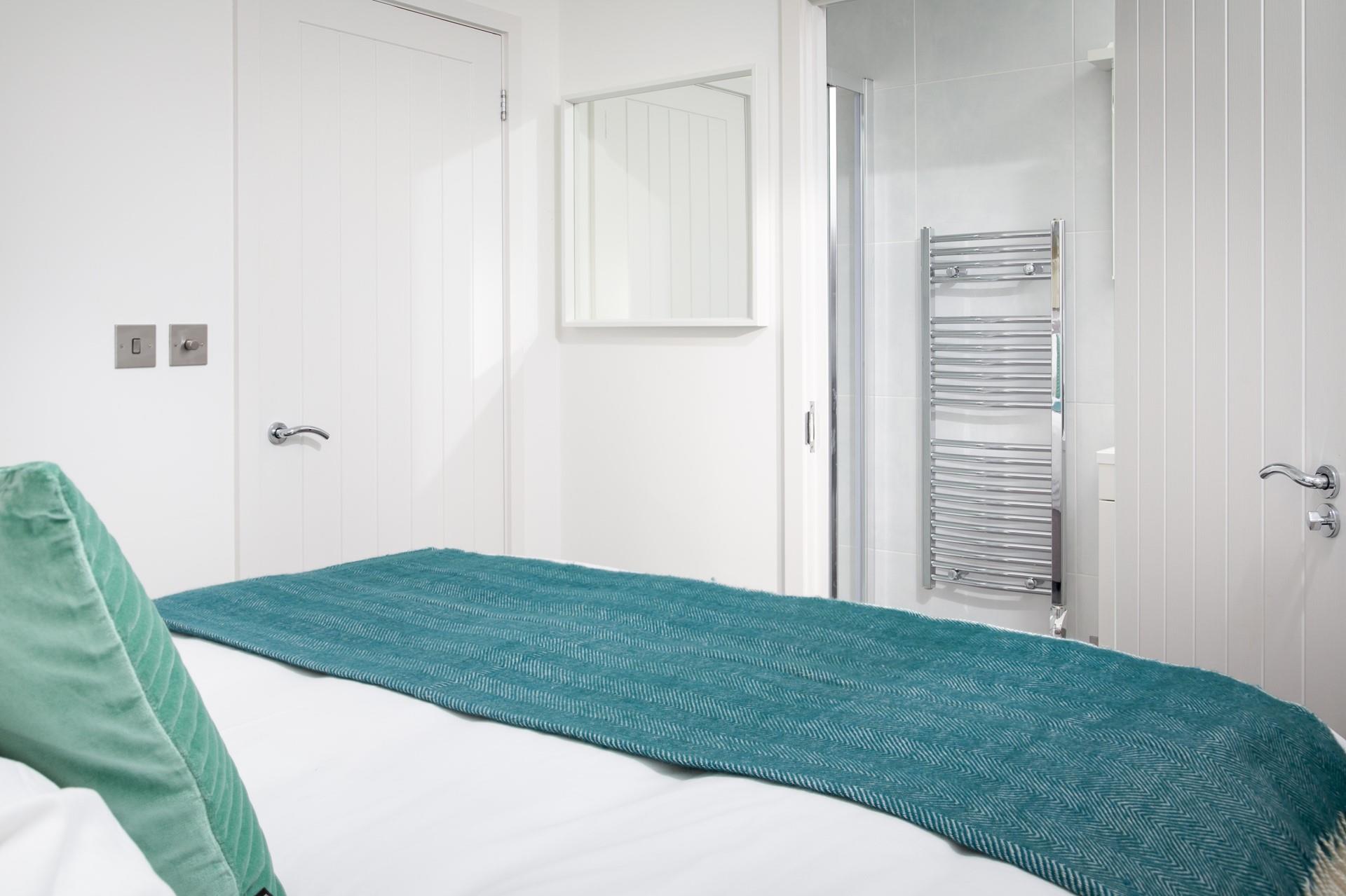 The minimalistic decor and comforting colours ensure the bedroom is a calming room to relax in at the end of the day.