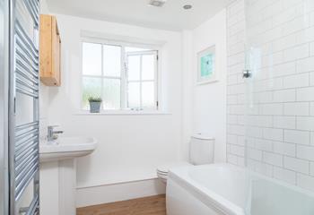 The bathroom has a minimalistic design, creating a fresh and uncluttered space.