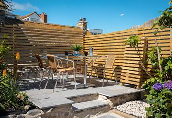 Dining al fresco is made easy in the suntrap outdoor area complete with a table and chairs, perfect for lazy lunches.