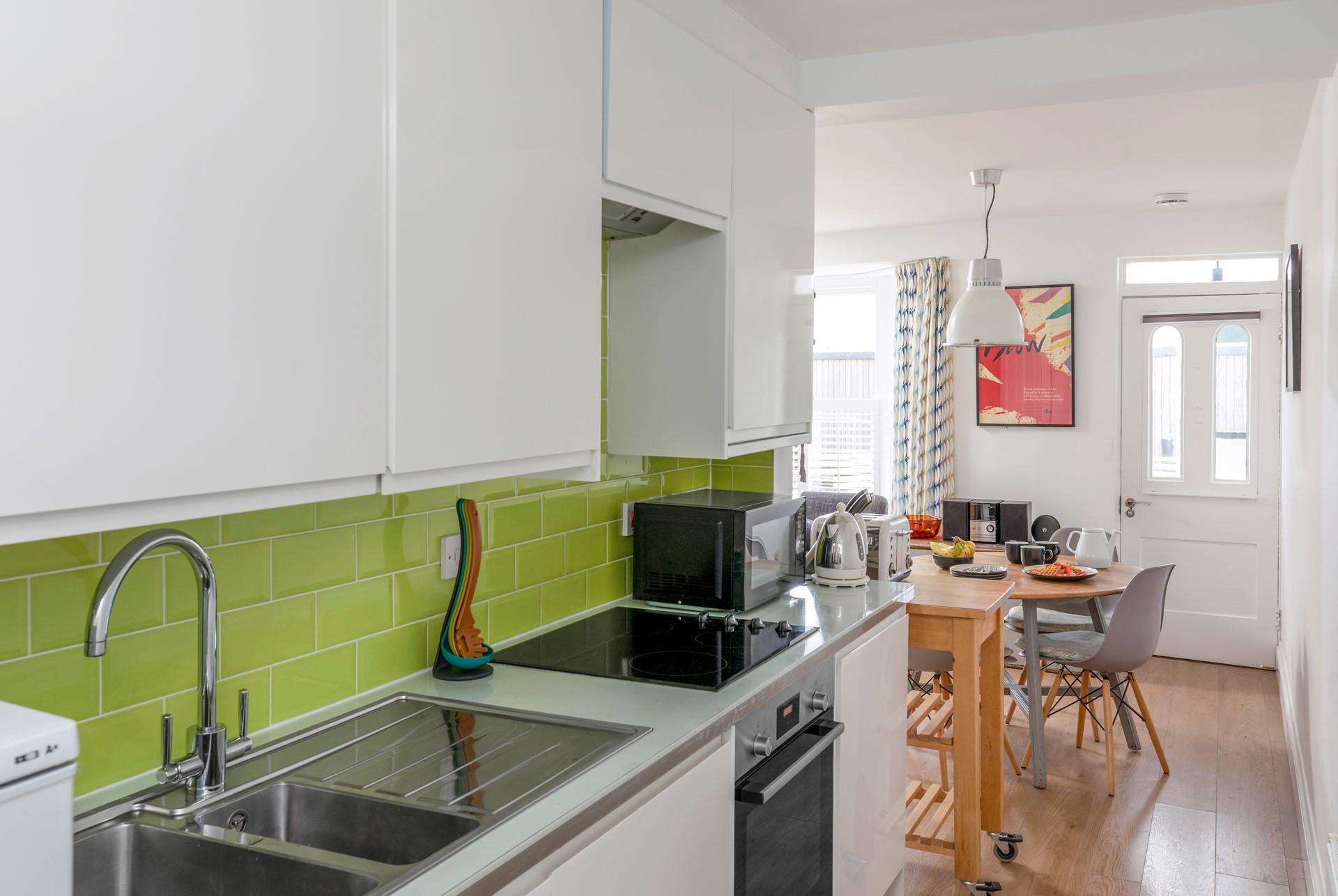 The bright and modern kitchen is well-equipped with modern appliances to make cooking delicious meals for your loved ones a breeze.