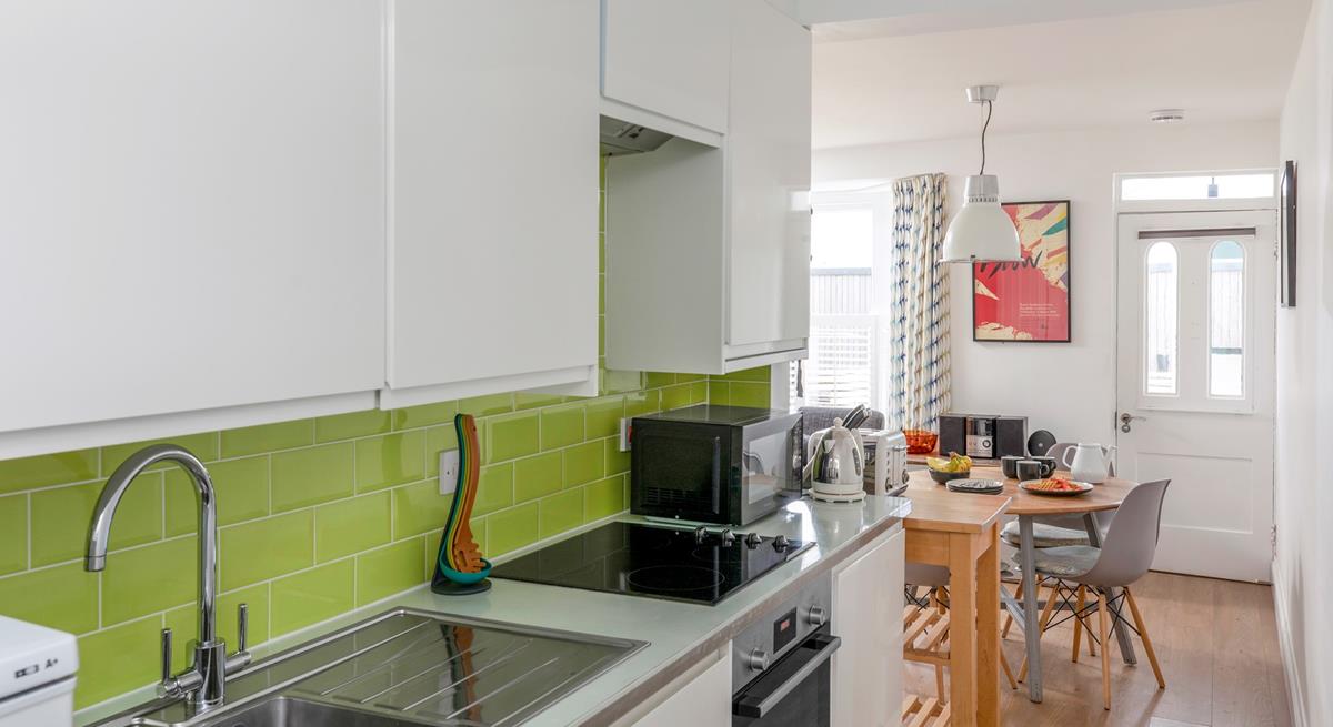 The bright and modern kitchen is well-equipped with modern appliances to make cooking delicious meals for your loved ones a breeze.