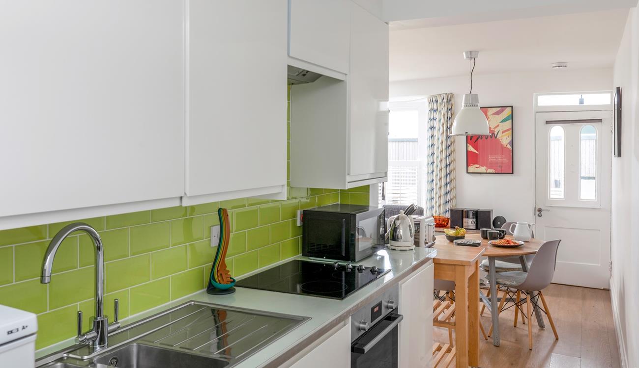 The bright and modern kitchen is well-equipped with modern appliances to make cooking delicious meals for your loved ones a breeze.