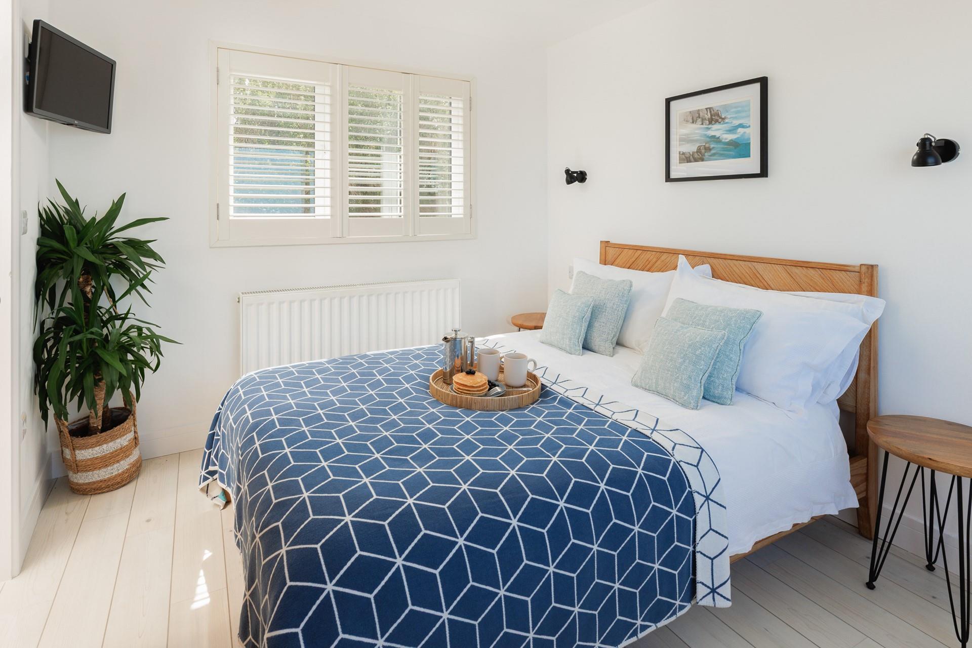 Modern decor and coastal blues adorn bedroom 3.