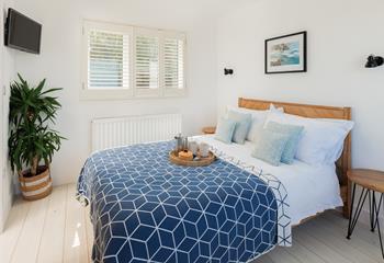 Modern decor and coastal blues adorn bedroom 3.