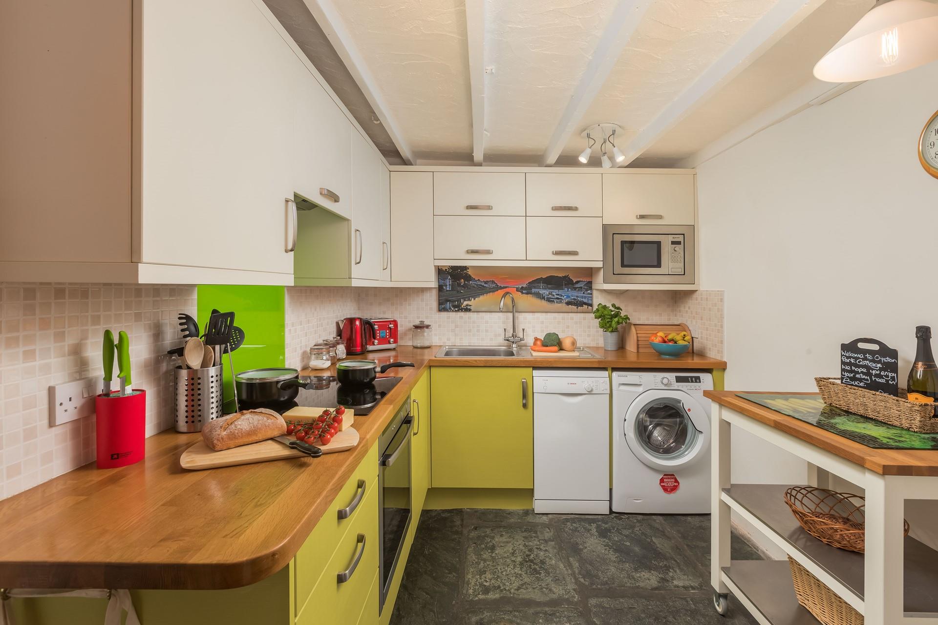 The kitchen has a pop of colour and is fully equipped for cooking tasty meals.