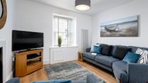 Get cosy in the living area and enjoy your favourite film on the smart TV.