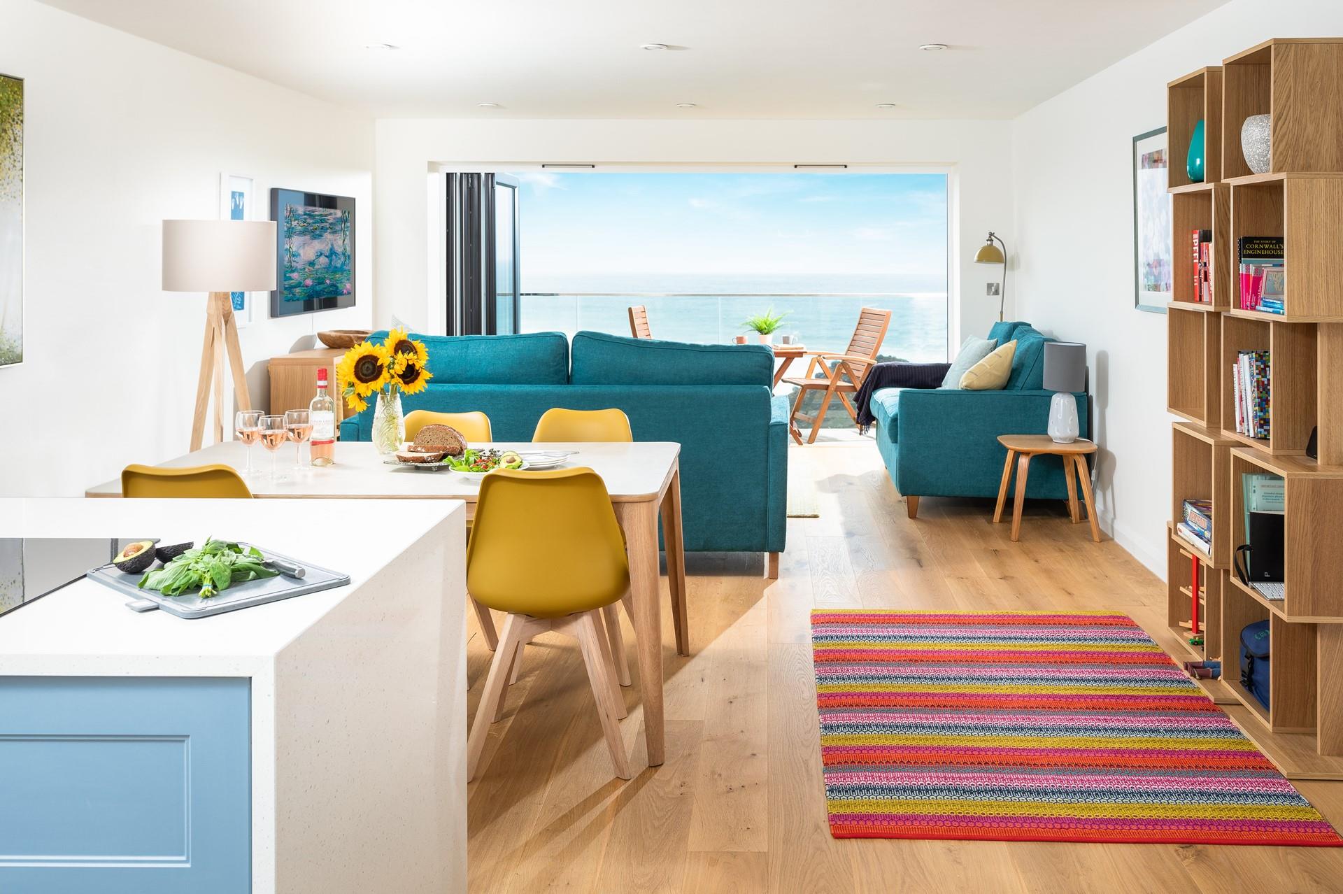 The open plan living space is colourful and bright with soft furnishings making for a relaxing home from home.