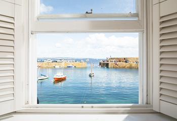 Gaze out at the boats bobbing in the harbour with a glass of something in hand.
