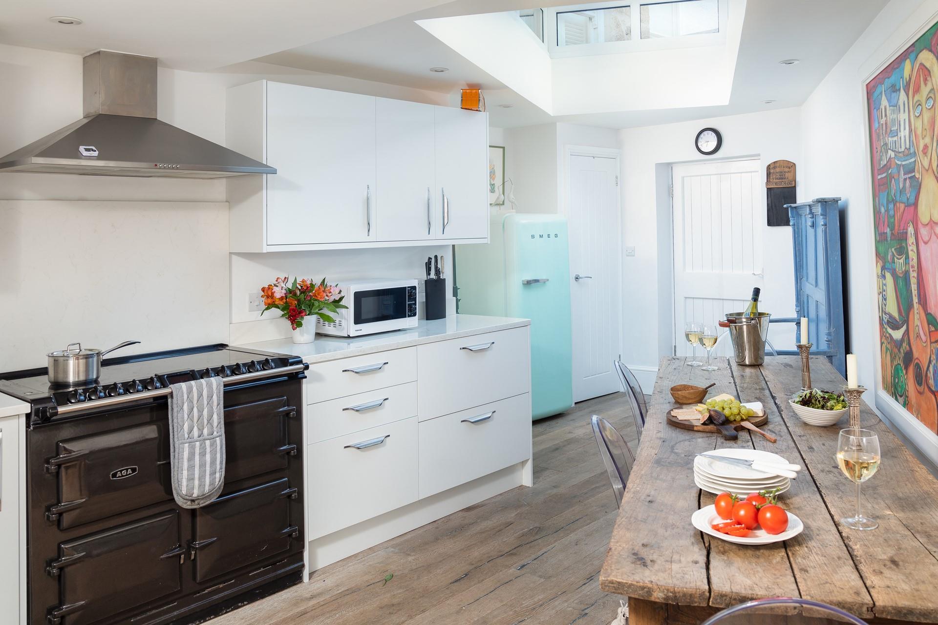 Cook a hearty meal in the Aga and enjoy it around the rustic dining table.