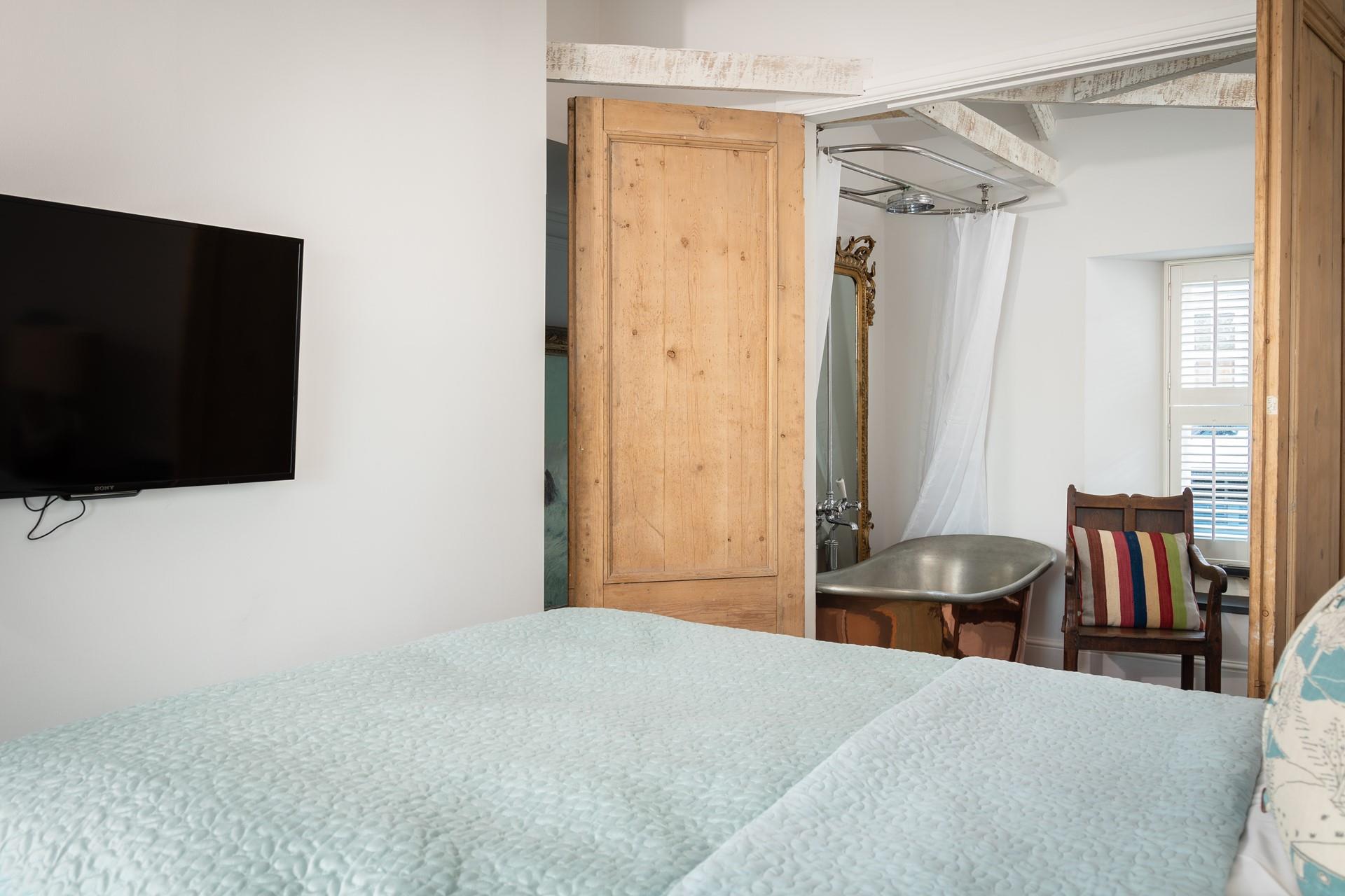 Wander out of bed and through the wooden doors to the bedroom.