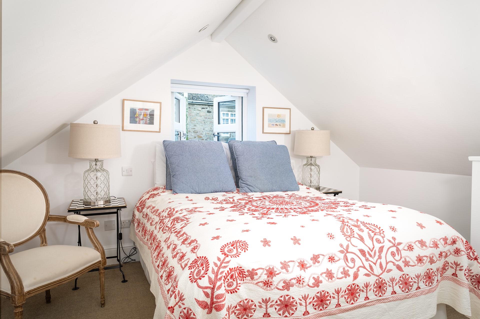 Bedroom 2 has a cosy double bed, open the windows and listen to the waves.