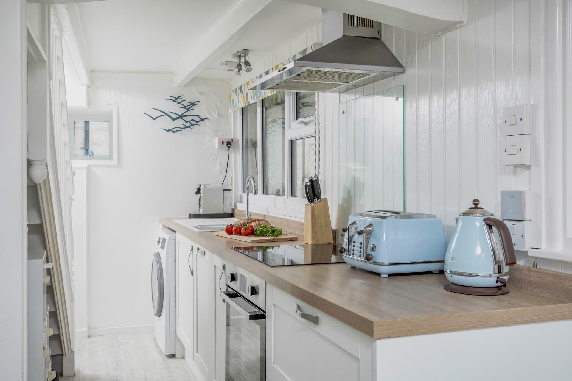 The contemporary kitchen includes everything our guests could need including a washer-dryer, dishwasher and a Nespresso coffee machine