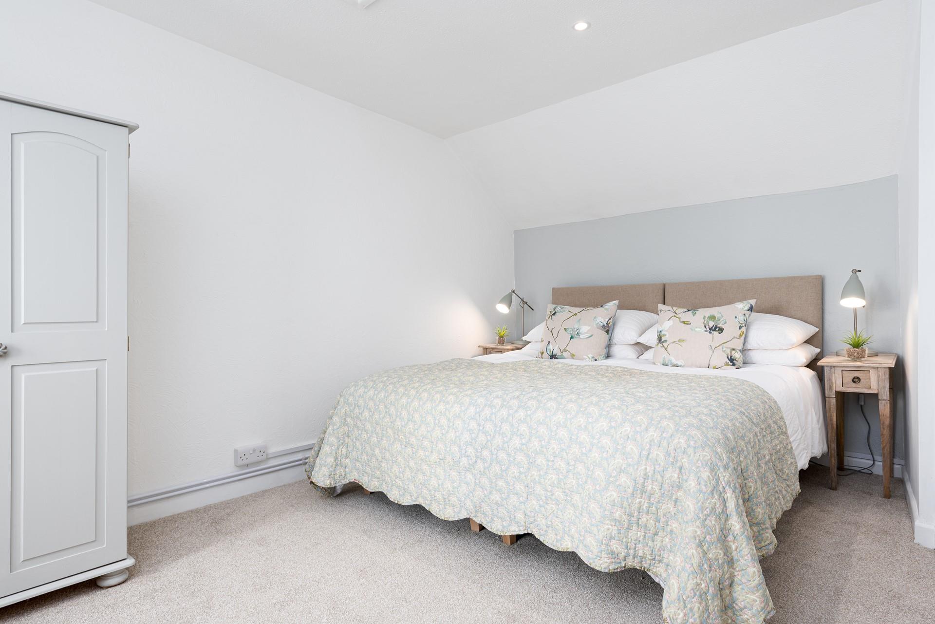 The large bed with a comfortable mattress promises you a good night's sleep leaving you rested and ready for the day ahead.