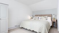 The large bed with a comfortable mattress promises you a good night's sleep leaving you rested and ready for the day ahead.