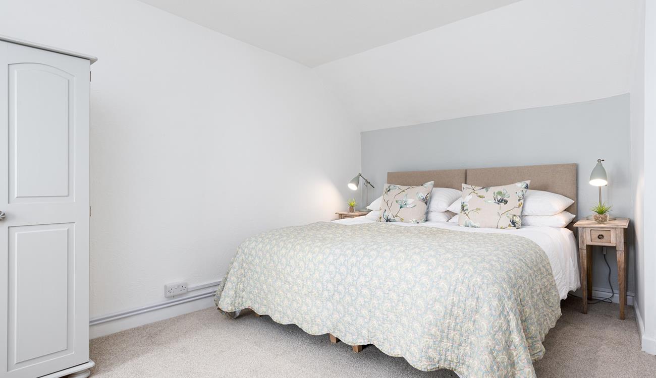 The large bed with a comfortable mattress promises you a good night's sleep leaving you rested and ready for the day ahead.