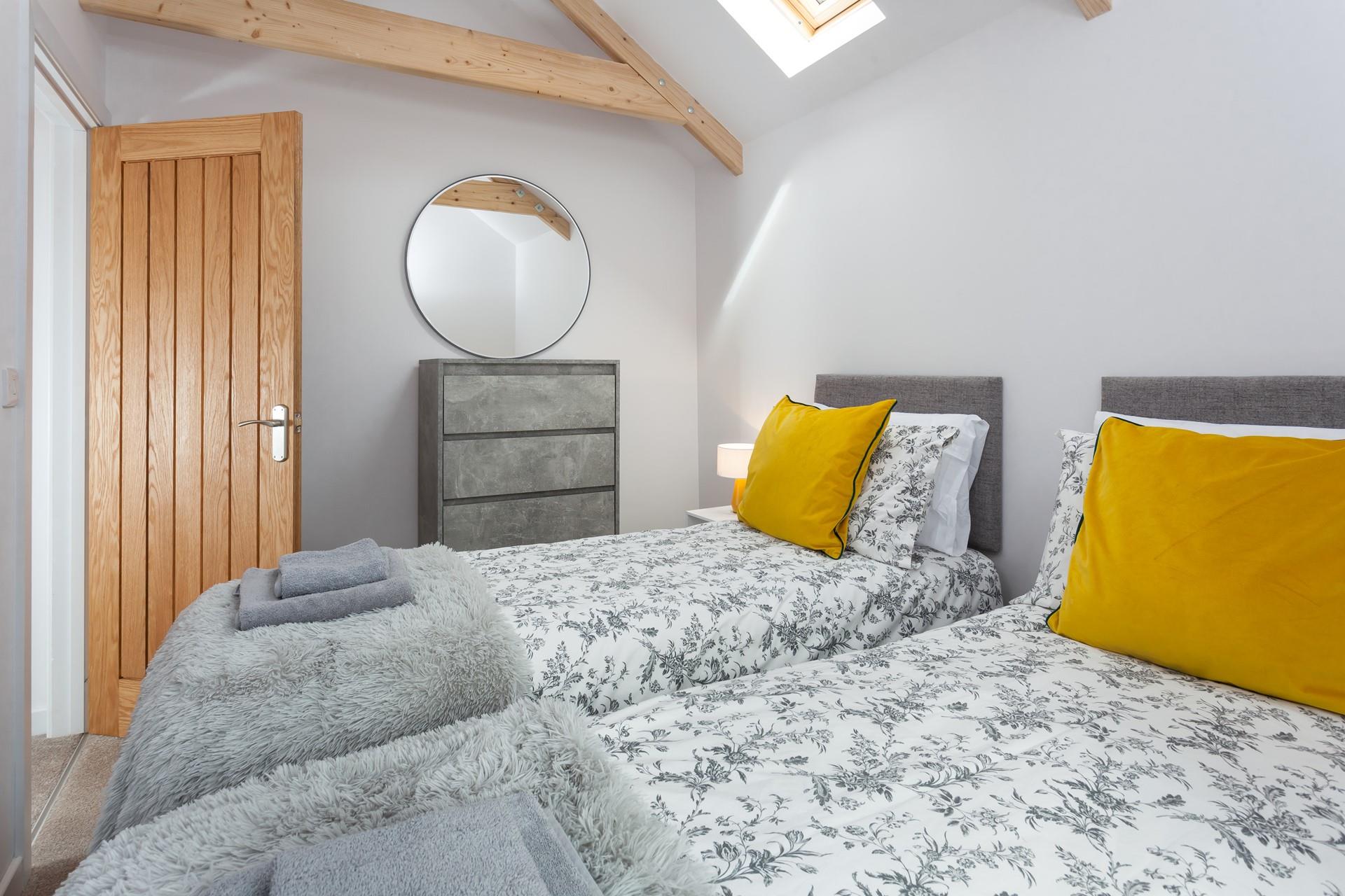 The bedrooms are decorated with greys and whites with a pop of colour.