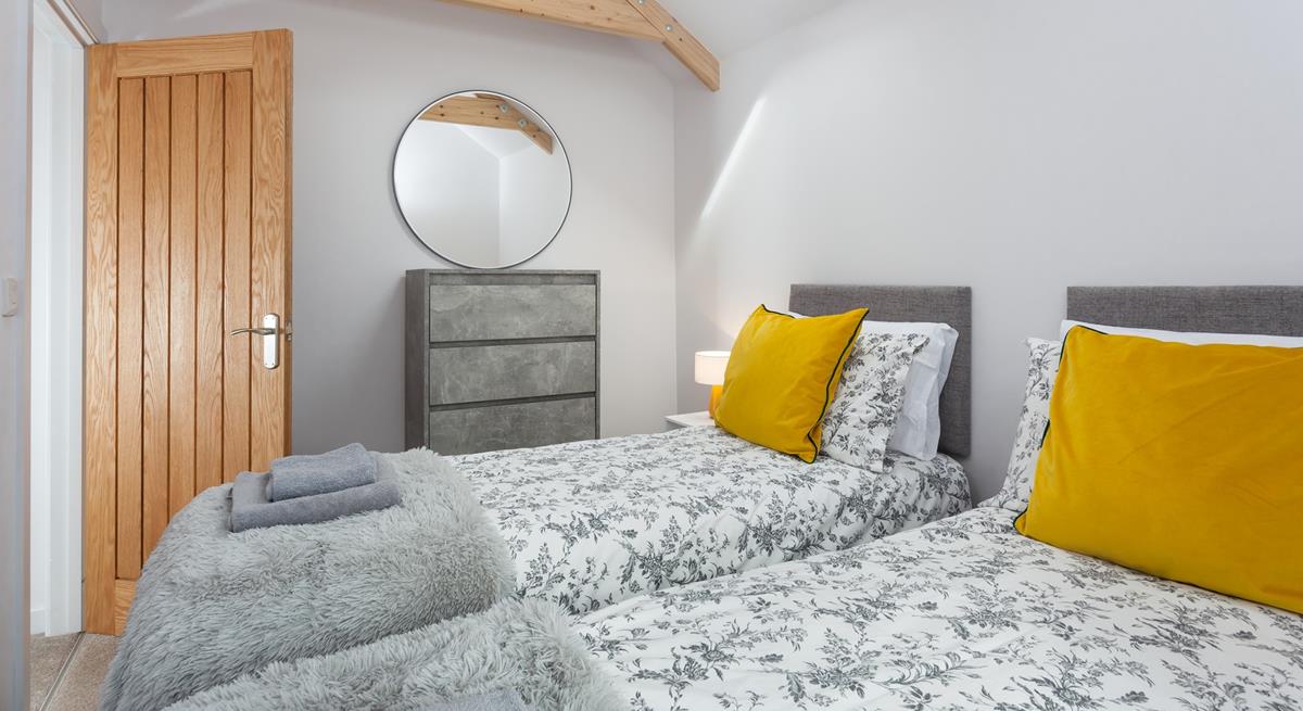 The bedrooms are decorated with greys and whites with a pop of colour.