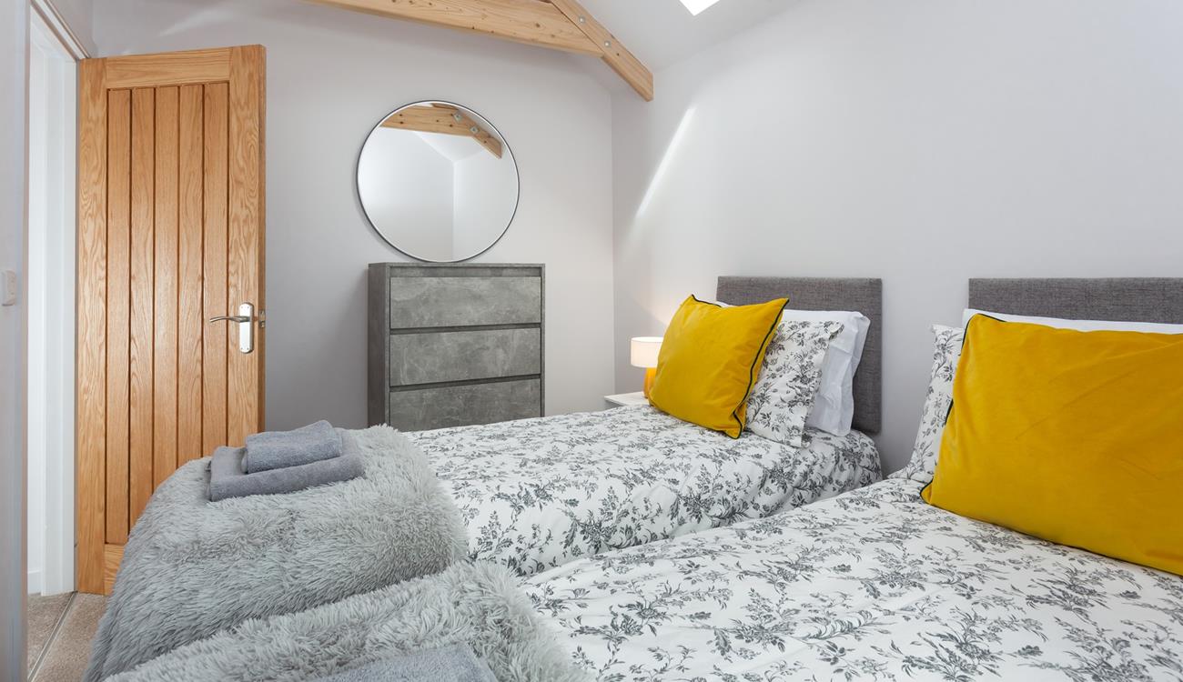 The bedrooms are decorated with greys and whites with a pop of colour.