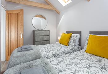 The bedrooms are decorated with greys and whites with a pop of colour.