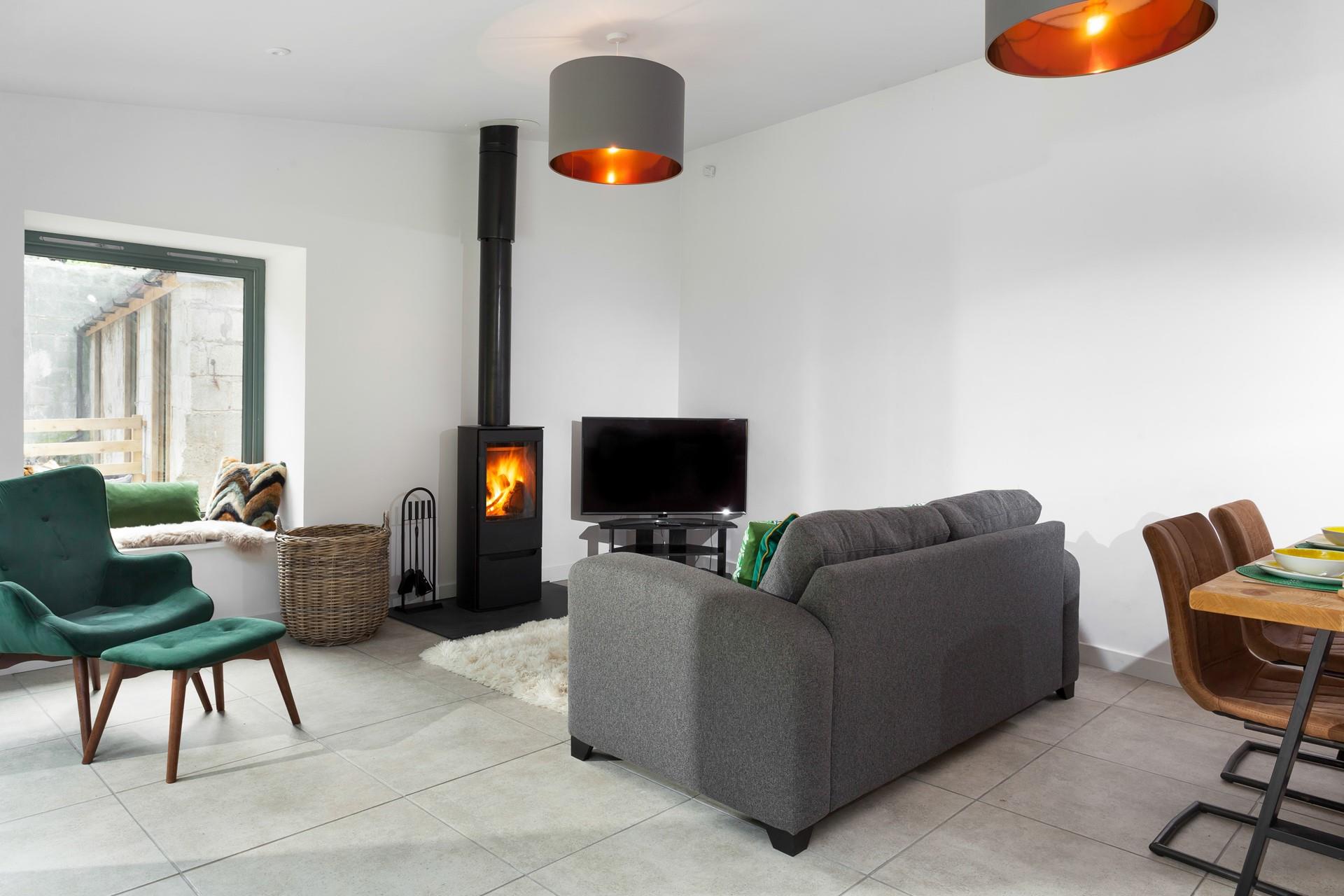 The cosy sitting room has a plush grey sofa to relax and unwind after a day of exploring.