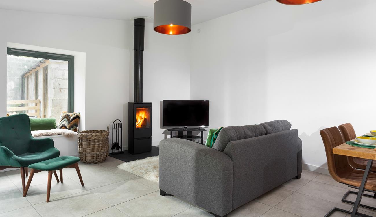 The cosy sitting room has a plush grey sofa to relax and unwind after a day of exploring.