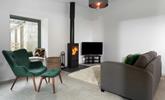 Listen to the crackling of the woodburner whilst you relax in the cosy sitting room. - Thumbnail Image
