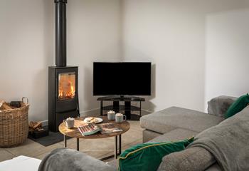 The cosy woodburner makes Boskennal Barn perfect for an autumn or winter break.