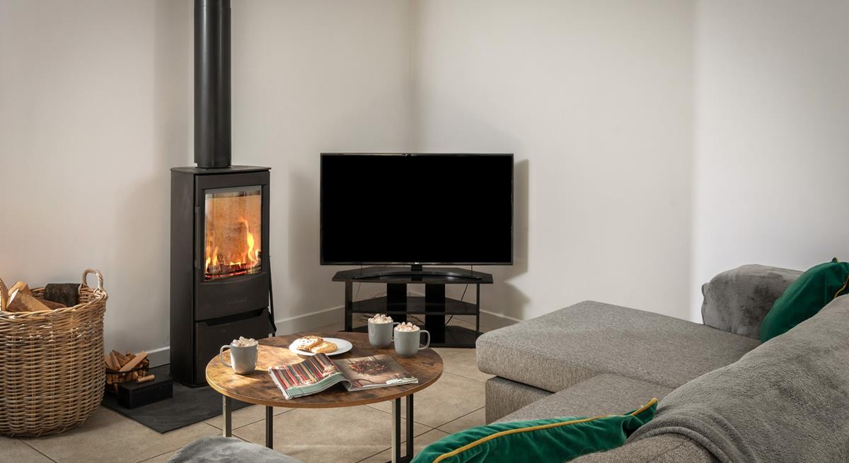 The cosy woodburner makes Boskennal Barn perfect for an autumn or winter break.