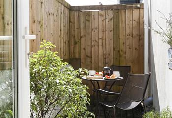 The quaint patio area is a tranquil spot for your morning coffee, away from the hustle and bustle.