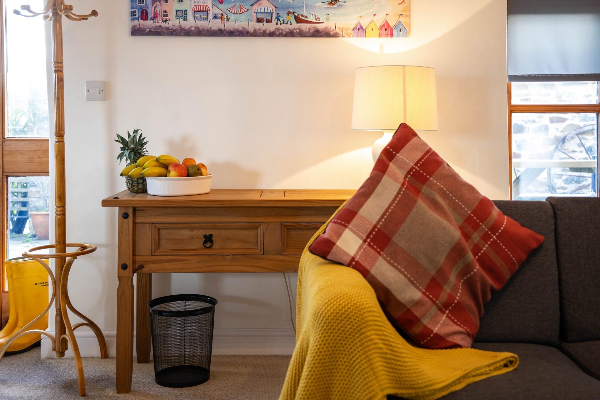 Cosy cushions, throws and artwork have created a welcoming living space.