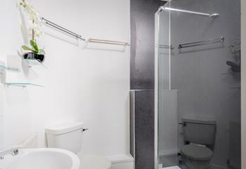 The bathroom has shower, WC and basin with an illuminated mirror over.