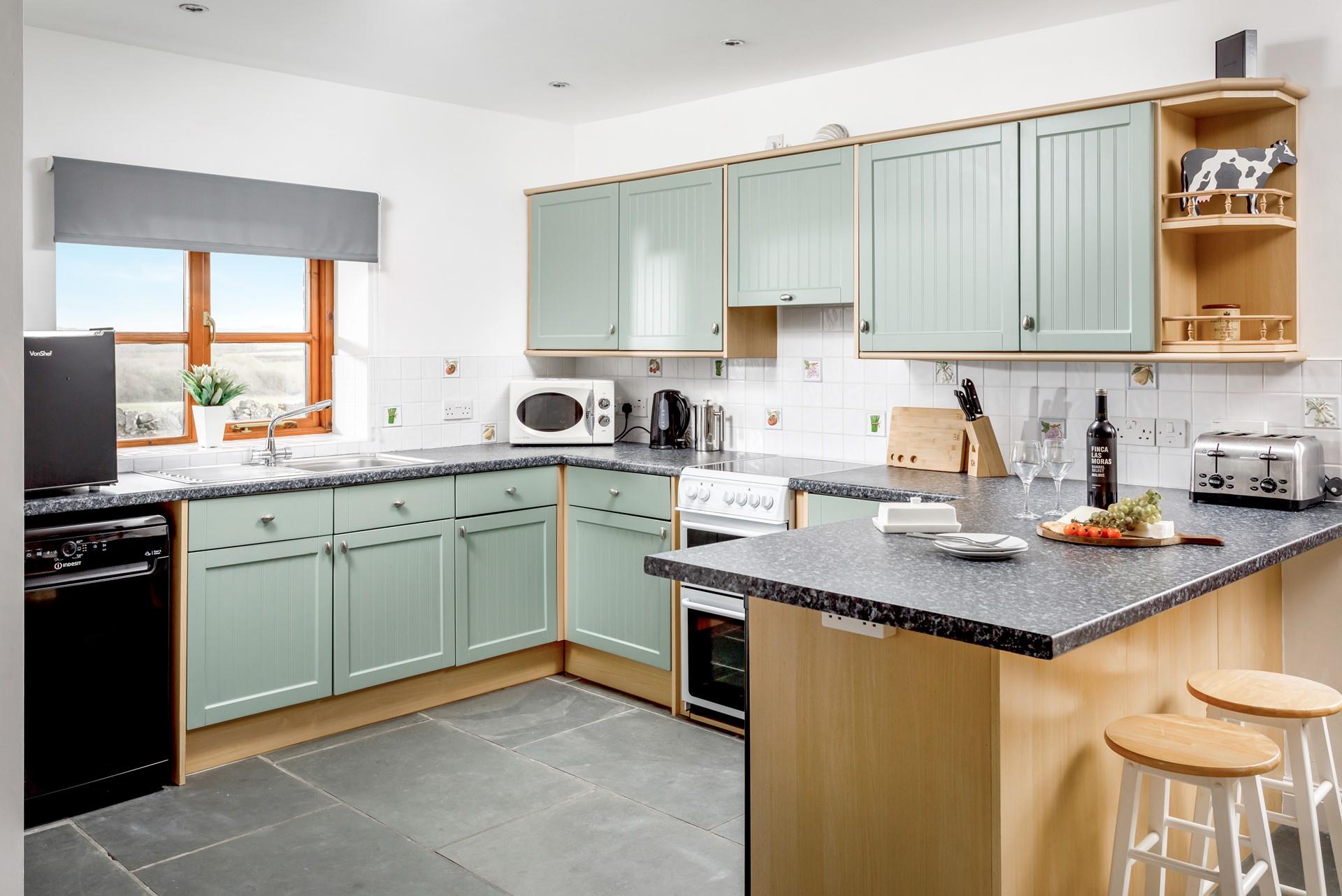The kitchen is modern and has all the handy appliances you need to cook up a storm.