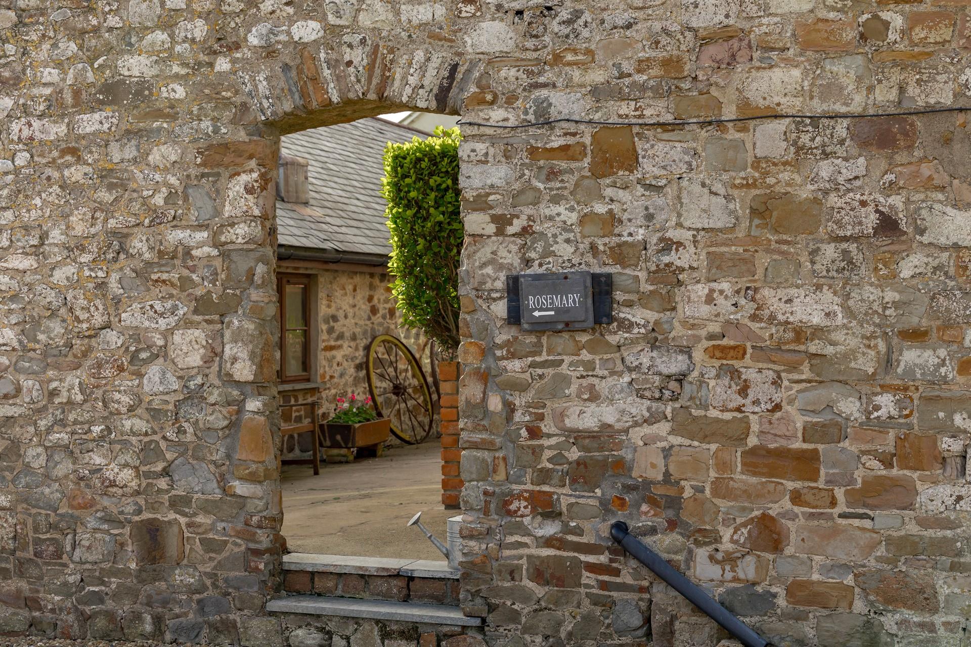Explore the pretty rose garden courtyard outside this delightful barn conversion.